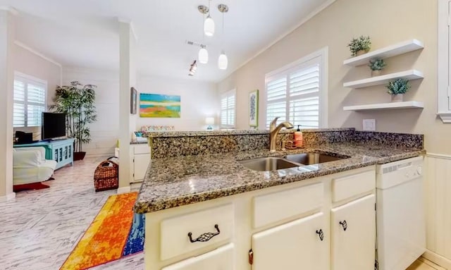 kitchen featuring dishwasher, stone countertops, crown molding, and sink