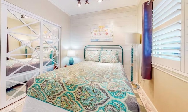 bedroom with wood-type flooring and ornamental molding