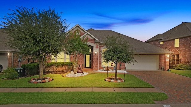 view of front of house with a yard and a garage