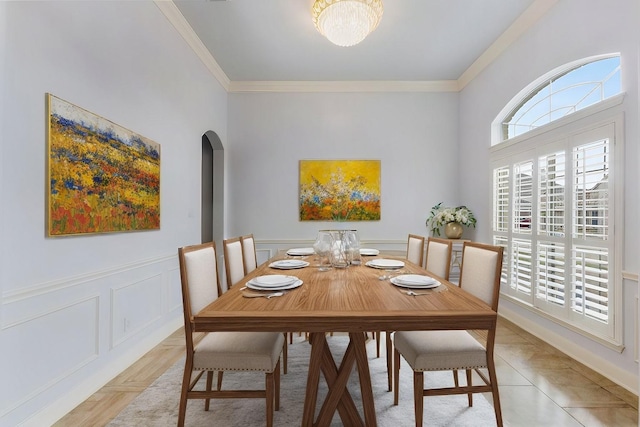 dining room featuring light tile patterned floors and crown molding