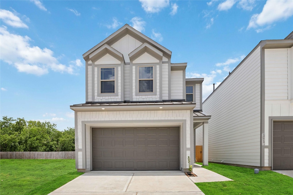 view of front of property featuring a garage and a front yard