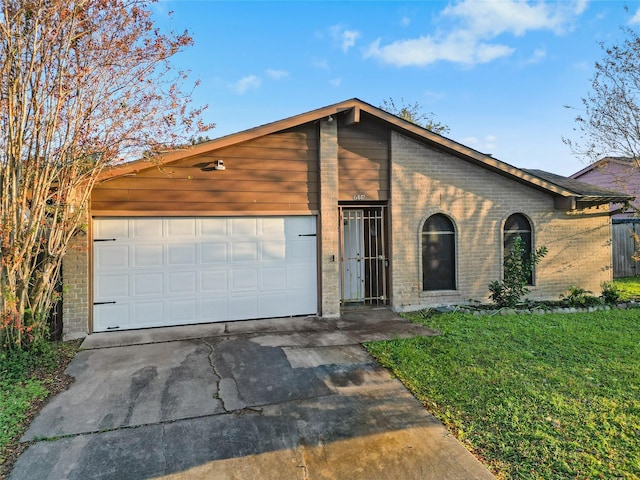 view of front facade with a garage and a front lawn