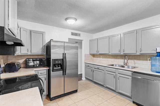 kitchen featuring black appliances, light tile patterned flooring, sink, and tasteful backsplash