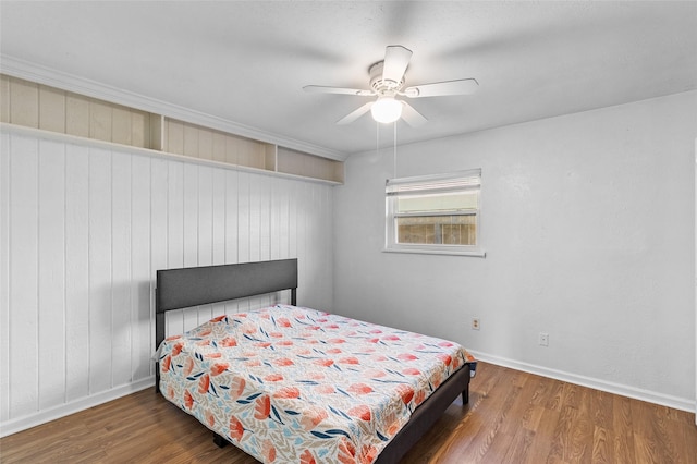 bedroom with hardwood / wood-style floors and ceiling fan