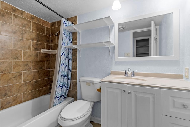 full bathroom featuring vanity, a textured ceiling, toilet, and shower / tub combo with curtain