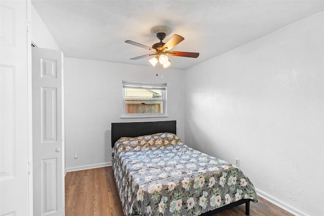 bedroom with hardwood / wood-style floors and ceiling fan