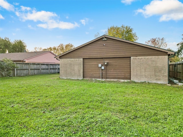 view of outbuilding featuring a lawn