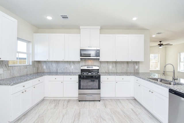 kitchen with white cabinetry, sink, and appliances with stainless steel finishes