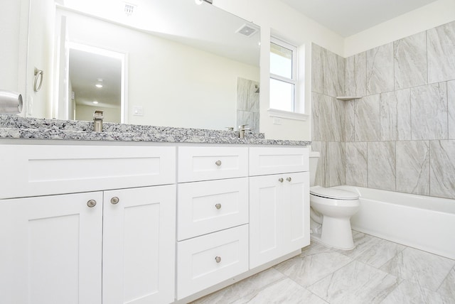 full bathroom with vanity, toilet, and tiled shower / bath