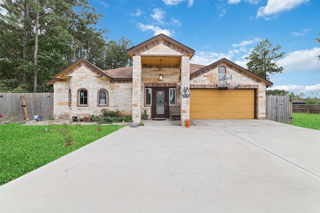 view of front of property with a garage and a front lawn