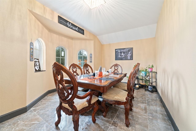 dining space with vaulted ceiling