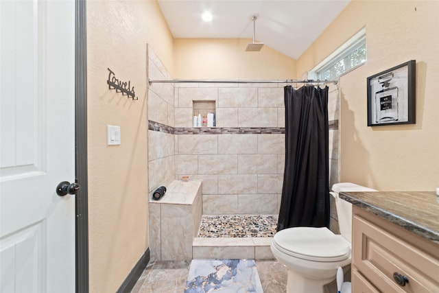 bathroom with vanity, curtained shower, toilet, and vaulted ceiling