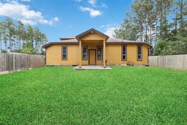 rear view of house featuring a yard