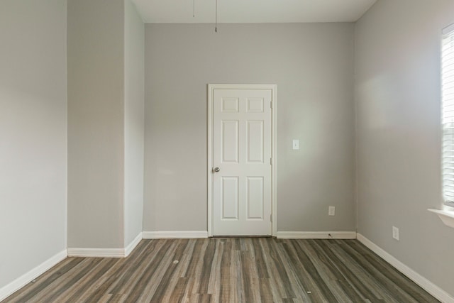 spare room with dark hardwood / wood-style floors