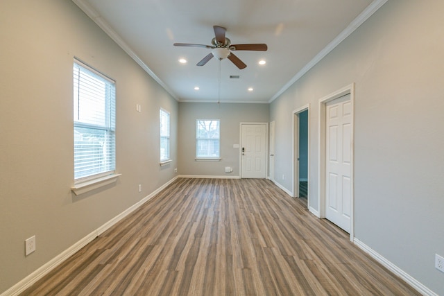 interior space with hardwood / wood-style floors, ceiling fan, and crown molding