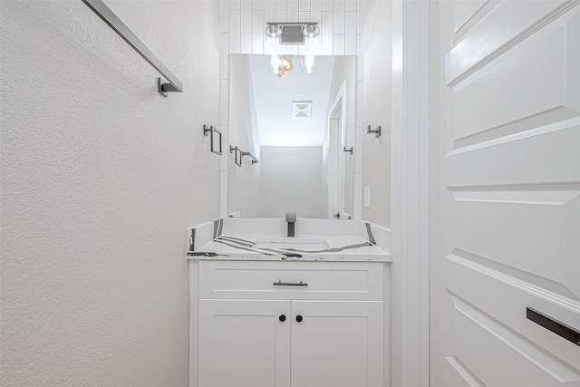 bathroom with vanity and a shower with shower door