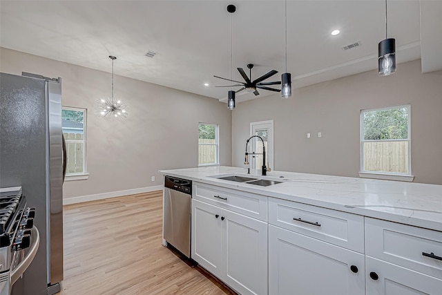 kitchen with white cabinets, pendant lighting, appliances with stainless steel finishes, and sink