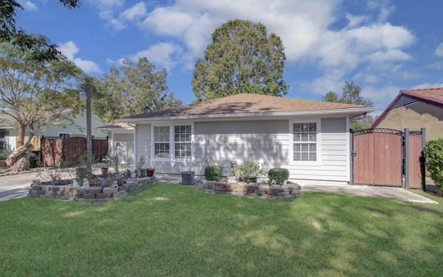 rear view of property featuring a lawn