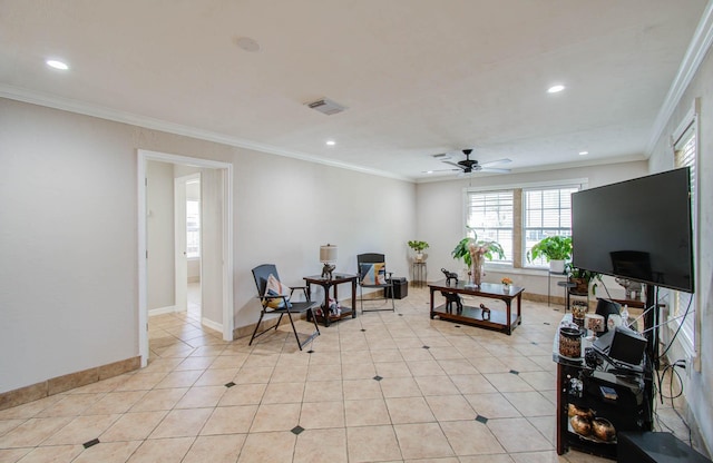 living area with crown molding, ceiling fan, and light tile patterned floors