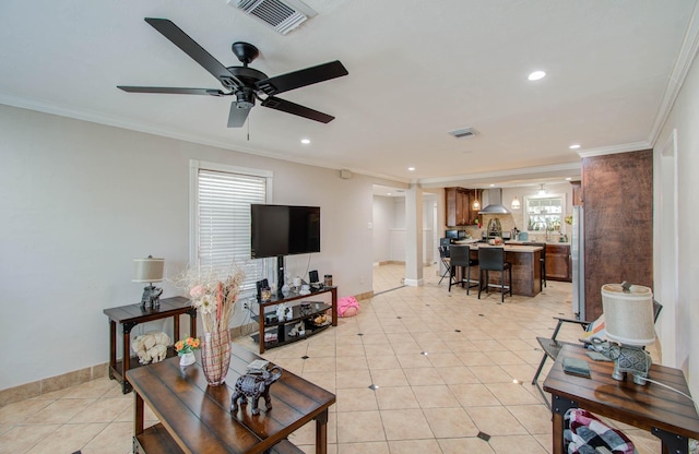 living room featuring ceiling fan, ornamental molding, and light tile patterned floors