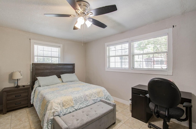 bedroom featuring a textured ceiling, ceiling fan, and light tile patterned flooring