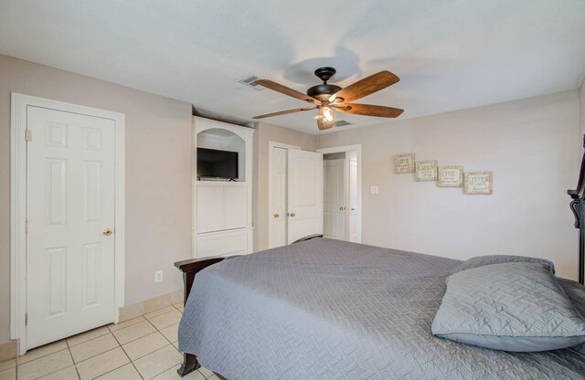 bedroom featuring ceiling fan and light tile patterned floors