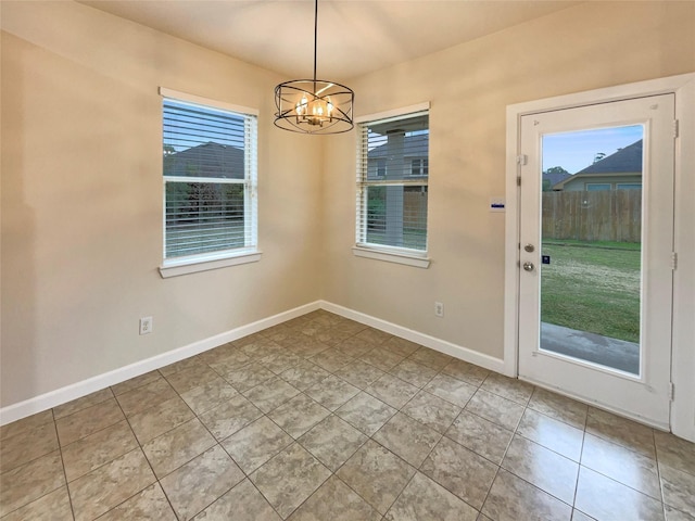 unfurnished dining area with light tile patterned flooring, a wealth of natural light, and an inviting chandelier