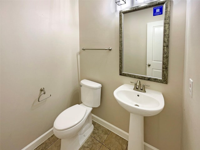 bathroom with tile patterned flooring, toilet, and sink