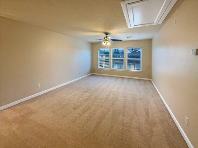 empty room featuring light colored carpet and ceiling fan