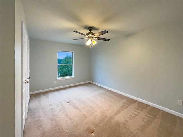 unfurnished room featuring light carpet and ceiling fan