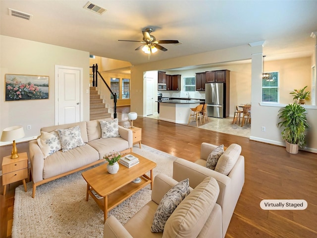 living room with ceiling fan and light hardwood / wood-style floors