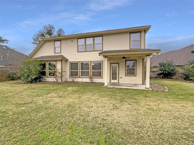 rear view of house featuring a lawn, ceiling fan, and a patio