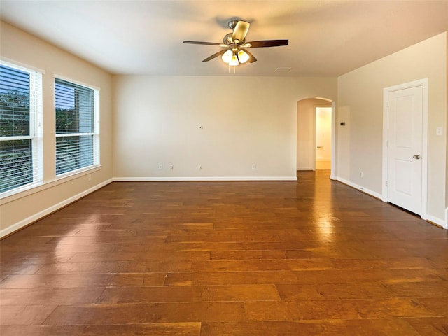 unfurnished room with dark hardwood / wood-style floors and ceiling fan