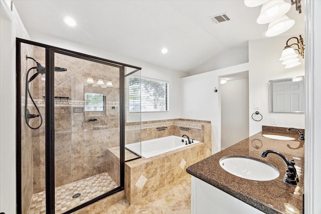 bathroom with vanity, lofted ceiling, and shower with separate bathtub