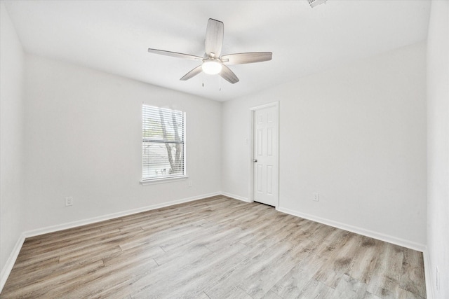 empty room featuring ceiling fan and light hardwood / wood-style flooring