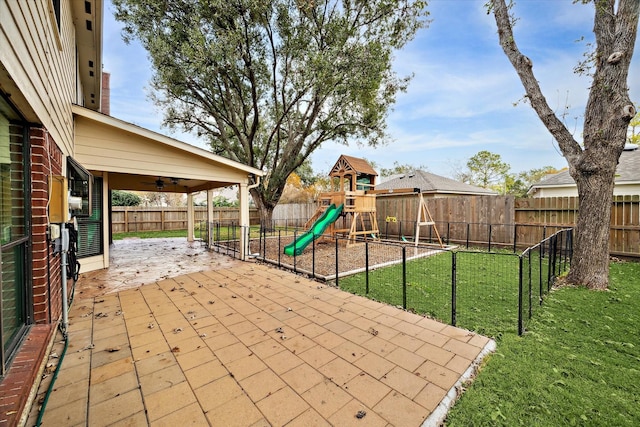 view of patio / terrace featuring a playground and ceiling fan