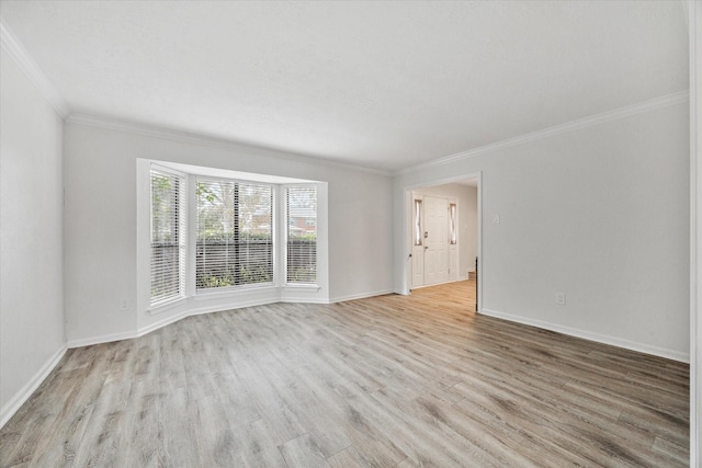 spare room with light hardwood / wood-style flooring and ornamental molding