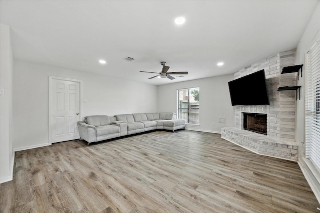 unfurnished living room with a fireplace, hardwood / wood-style floors, and ceiling fan