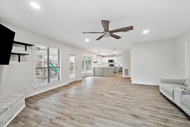 unfurnished living room with light hardwood / wood-style floors and ceiling fan