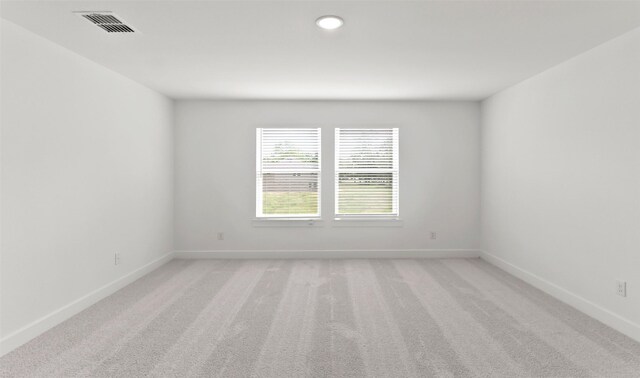 empty room featuring light carpet