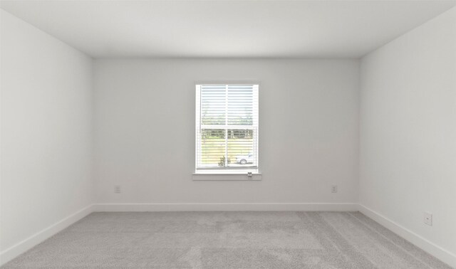 unfurnished room with light carpet