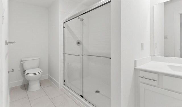 bathroom featuring tile patterned floors, vanity, toilet, and an enclosed shower