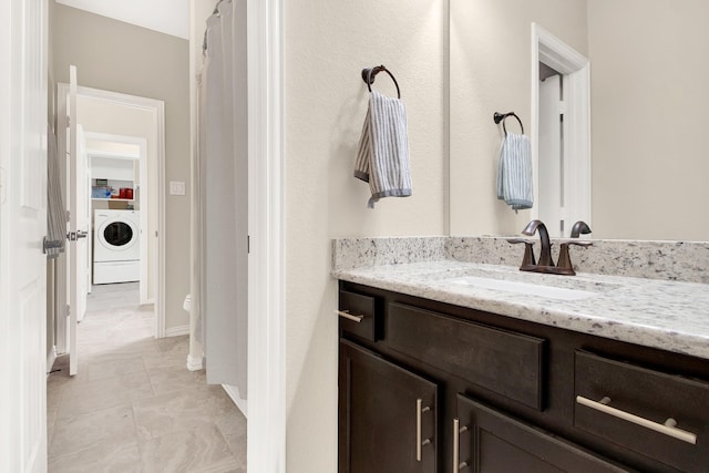 bathroom featuring washer / dryer and vanity