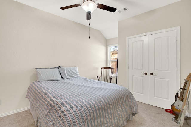 carpeted bedroom featuring a closet, vaulted ceiling, and ceiling fan