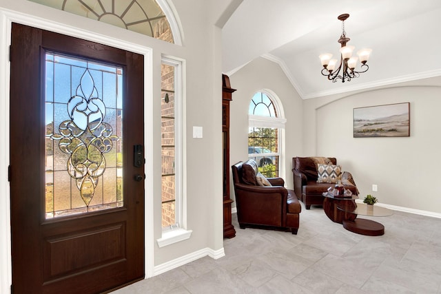 foyer with vaulted ceiling, plenty of natural light, ornamental molding, and a notable chandelier