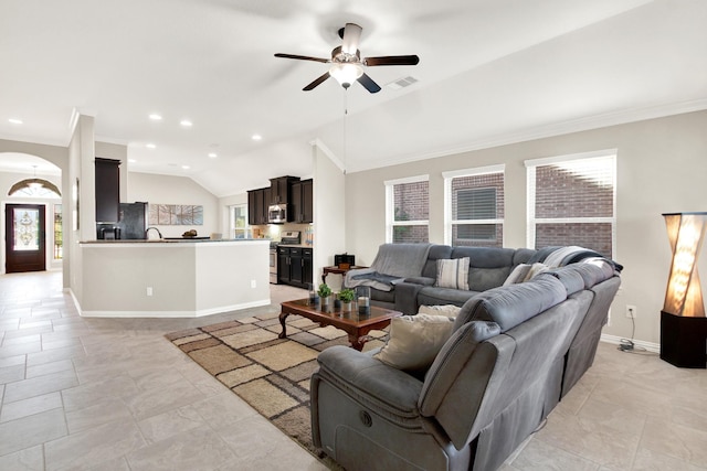 tiled living room featuring ceiling fan, lofted ceiling, and ornamental molding