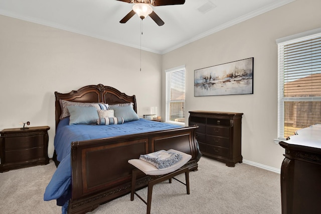 carpeted bedroom with multiple windows, ceiling fan, and ornamental molding