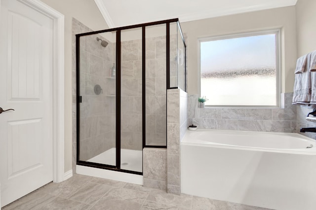 bathroom with plus walk in shower, crown molding, and a wealth of natural light