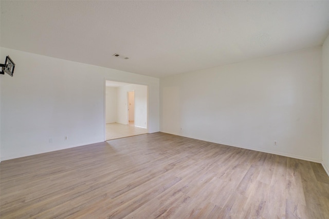 spare room featuring light wood-type flooring