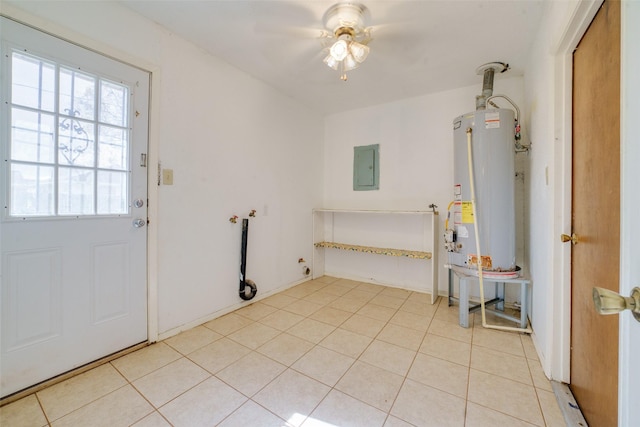 interior space with ceiling fan, hookup for an electric dryer, water heater, electric panel, and light tile patterned floors